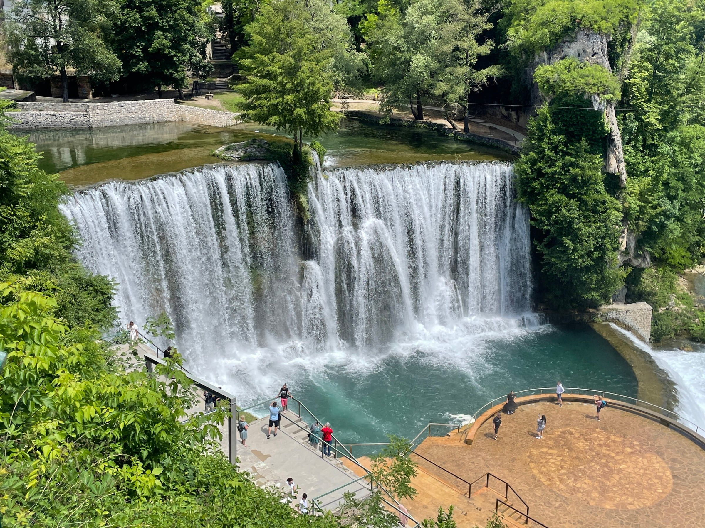 Pliva waterfall at Jajce, with water falling over the rock into the pool below.