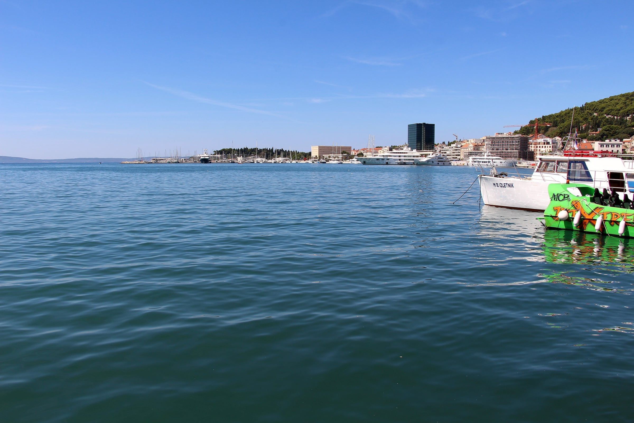 The Split waterfront and harbour, with boats moored along the promenade and the Adriatic beyond.