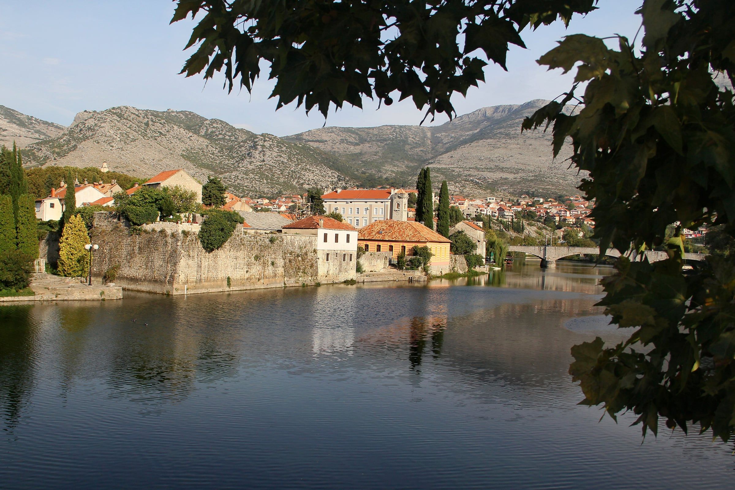The old town of Trebinje, with stone-built houses and trees.